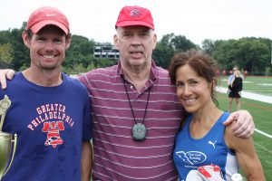 Peter Taylor posed with middle-distance greats Nick Berra and Lorraine Jasper after a 2013 meet.