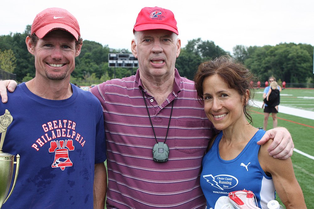 Peter Taylor posed with middle-distance greats Nick Berra and Lorraine Jasper after a 2013 meet.