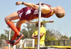 M60 Ed Baskauskas shows effort in high jump.