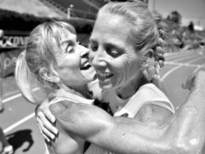 Lesley Hinz (left) hugs her friend Sue McDonald after Sue lowered her own W50 American record for the 800.