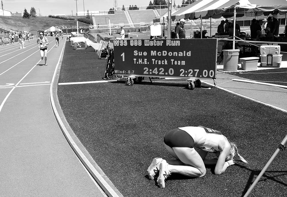 Sue McDonald recovers on infield after setting a W55 American record in the 800.