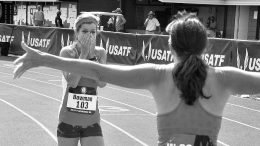 Becky Bowman, with a 14.15 windy 100, gets all-arms reception from W50 runner-up Amanda Scotti.