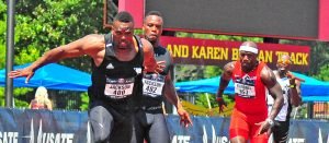 M35 Patrick Jackson hands off to twin brother and former NFL player Fred Jackson in a 4x100 relay.