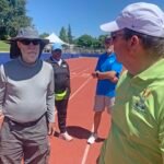 Jeff Davison (left) consults with Bill Murray while marking track for shuttle hurdles relay.