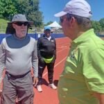 Jeff Davison (left) consults with Bill Murray while marking track for shuttle hurdles relay. P