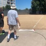 USATF field referee checks out shot put ring at American River College.